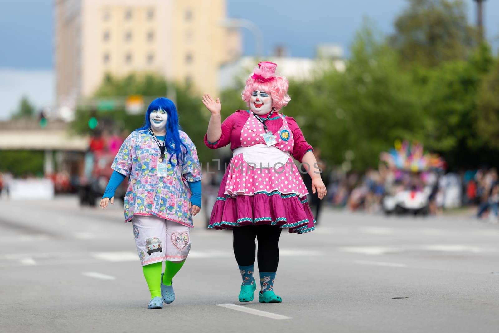 Louisville, Kentucky, USA - May 2, 2019: The Pegasus Parade, Two women dress up as clowns waving at the spectators during the parade