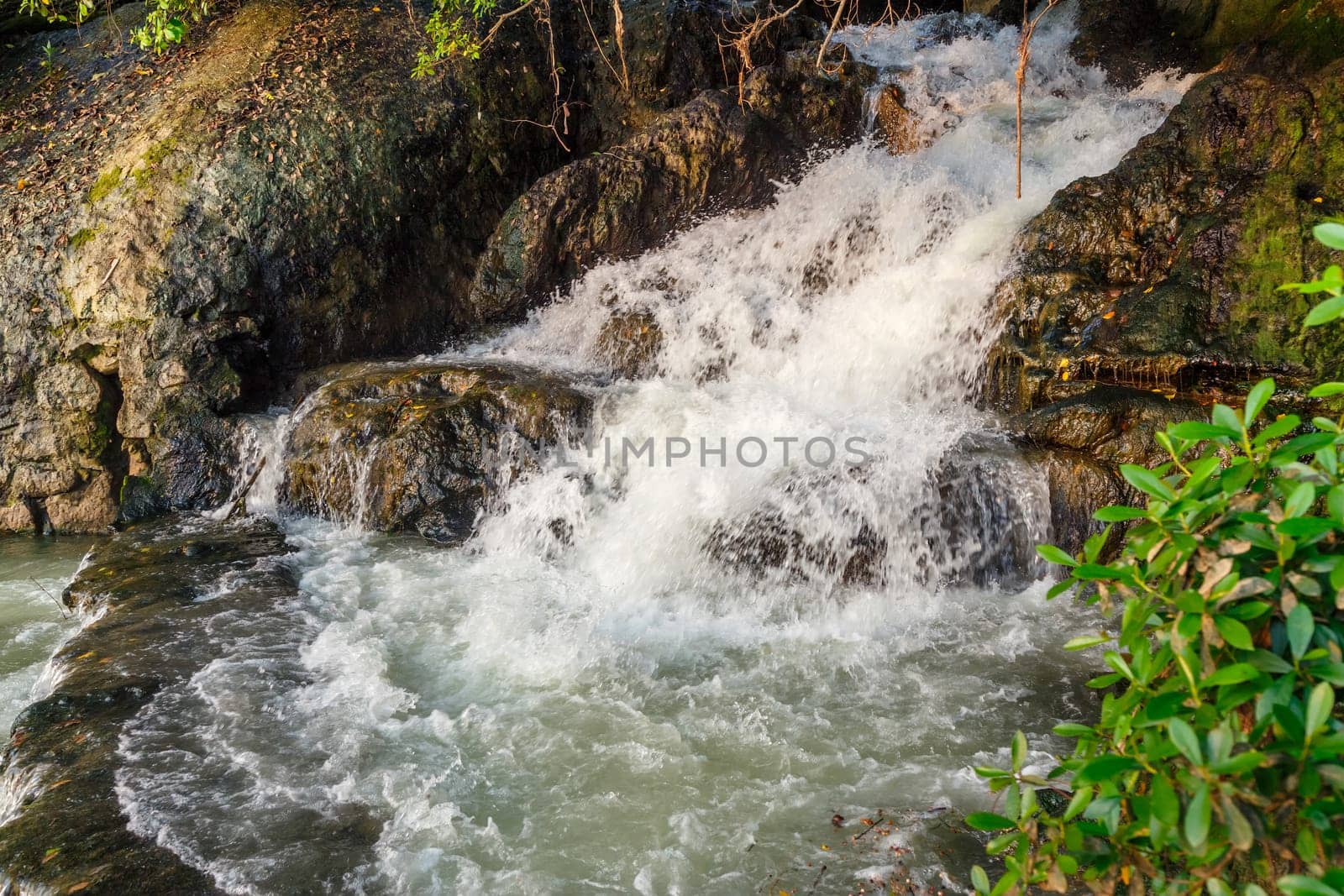 Streams of water from a rocky hill, mountain stream