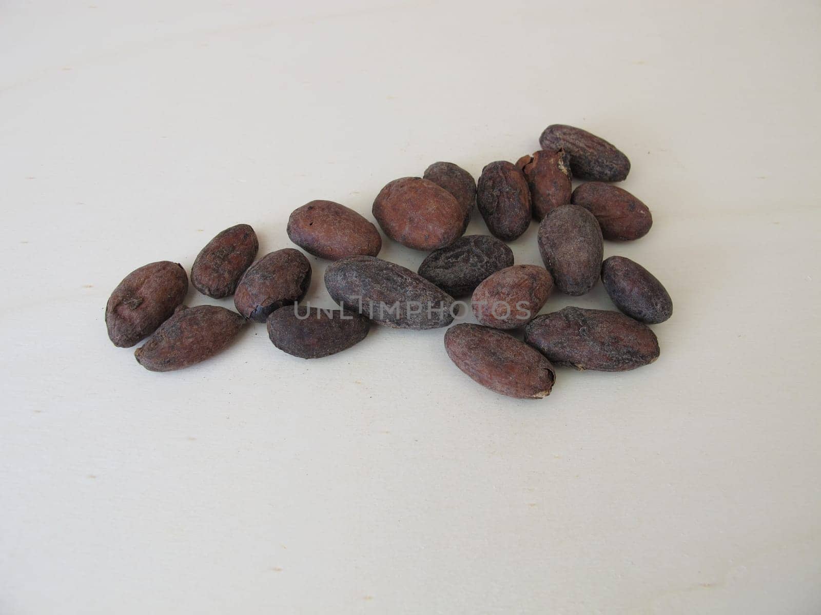Roasted cocoa beans on a wooden board