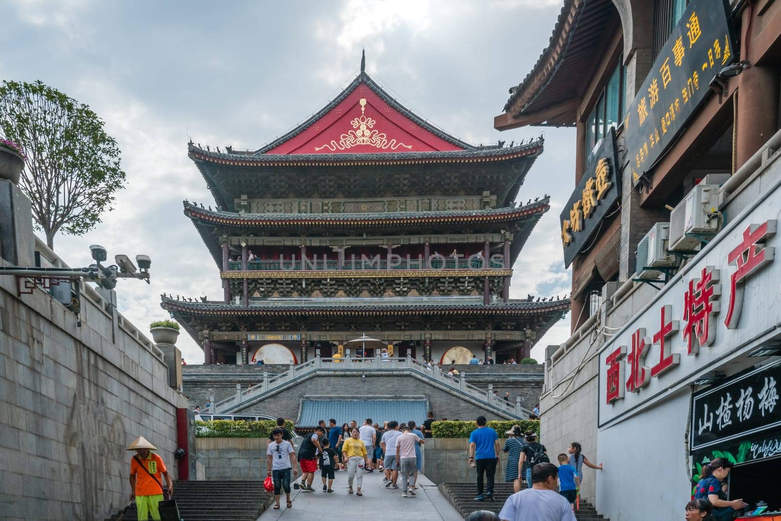 Xian, China -  July 2019 : People walking towards the landmark Drum Tower in the city Xian, Shaaxi Province