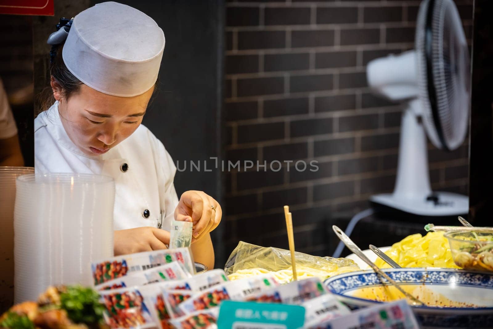 Xian, China -  July 2019 : Traditional local food vendor selling snacks on the street in the Muslim Quarter