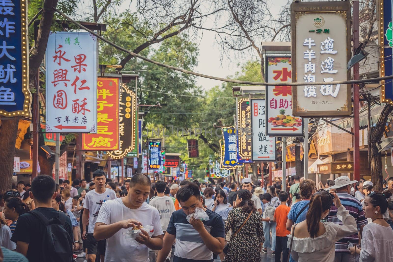 Xian, China -  July 2019 : Crowds visiting the popular street food district called Muslim Quarter in Xian, Shaanxi Province