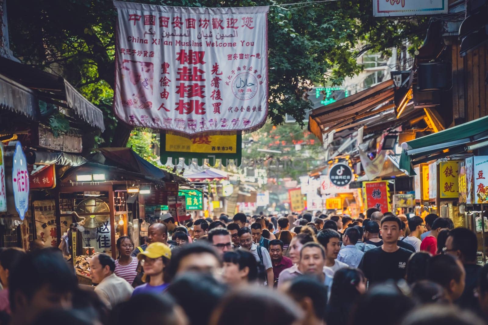 Xian, China -  July 2019 : Crowds visiting the popular street food district called Muslim Quarter in Xian, Shaanxi Province