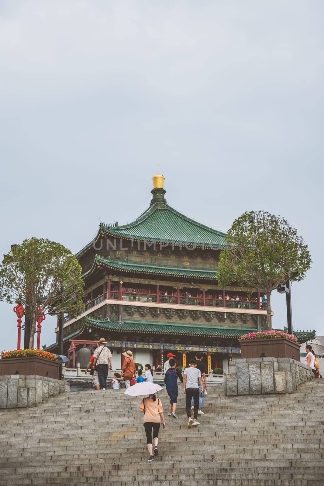 Xian, China -  July 2019 : People climbing up the stairs leading to the landmark Drum Tower in the city Xian, Shaaxi Province, Central China