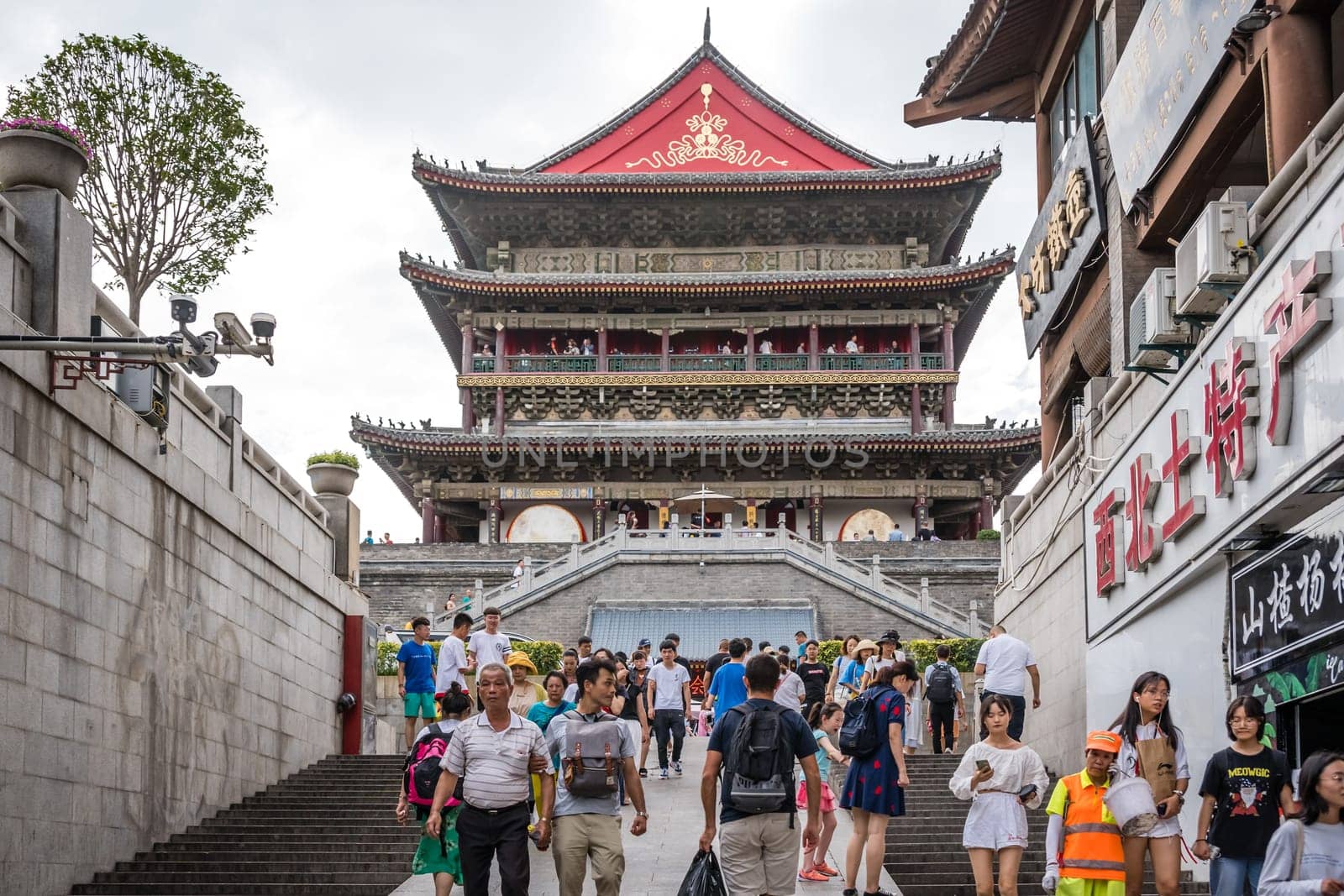 Xian, China -  July 2019 : People climbing up the stairs leading to the landmark Drum Tower in the city Xian, Shaaxi Province