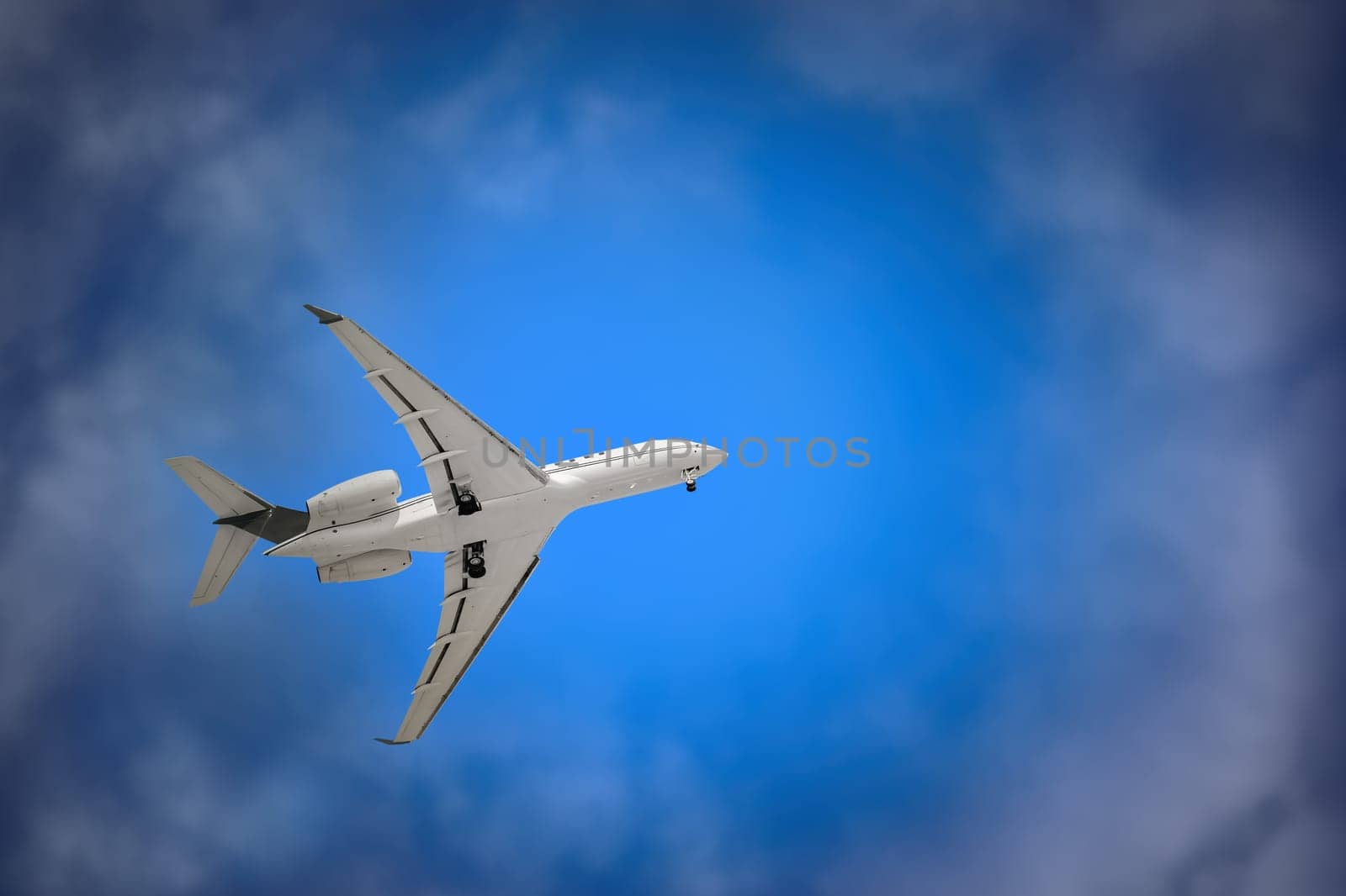 White Plane with Landing Gear in the Sky
