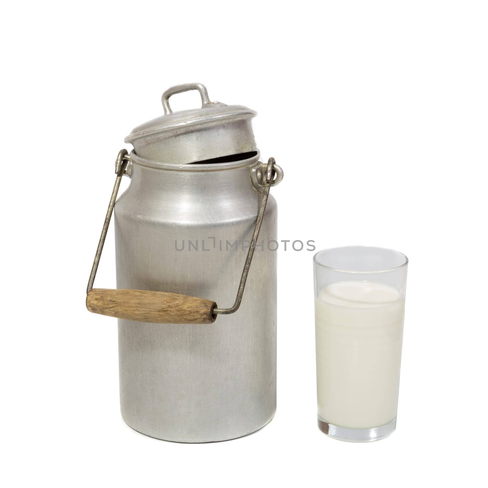 Glass of fresh milk and retro milk canister on white background