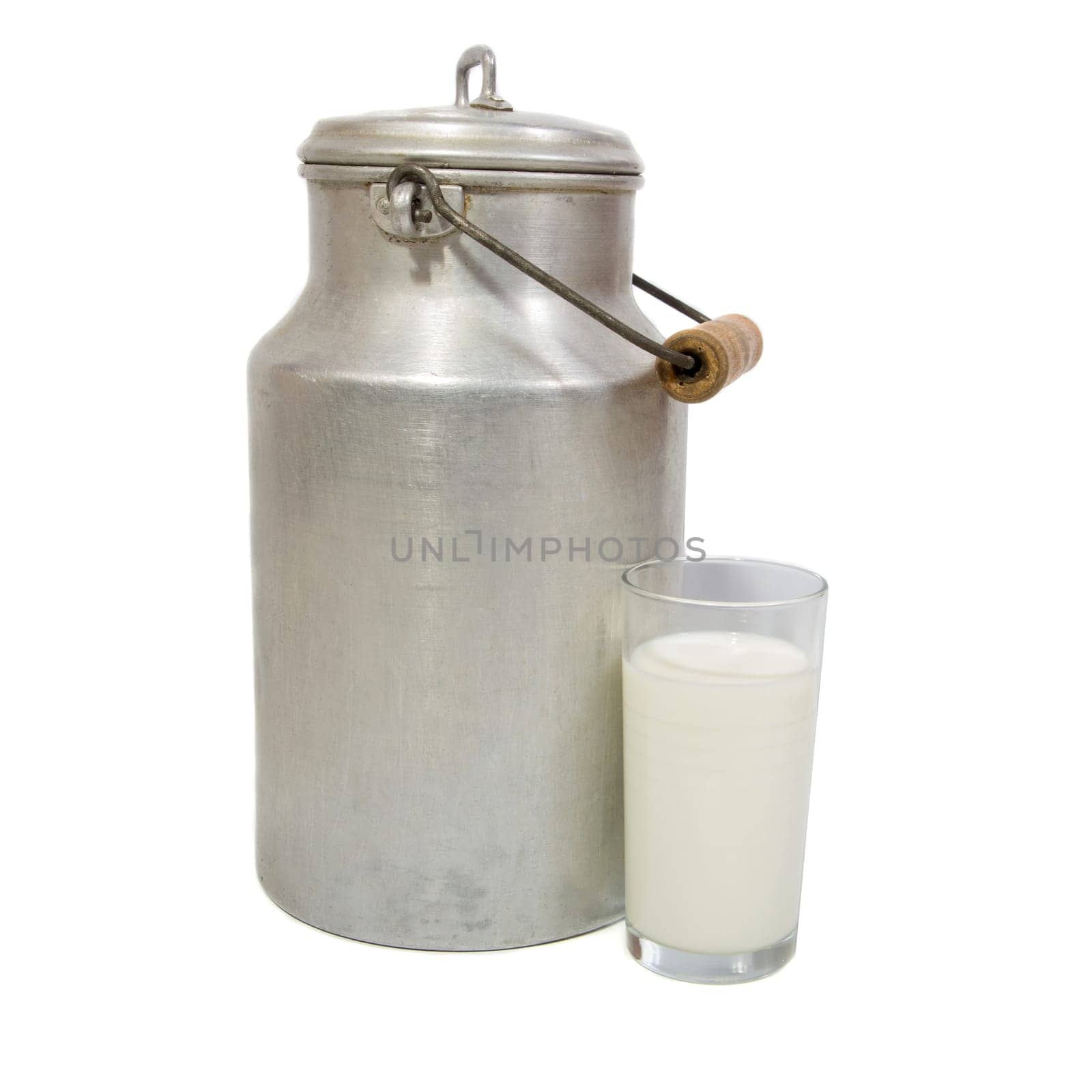 Glass of fresh milk and retro milk canister on white background