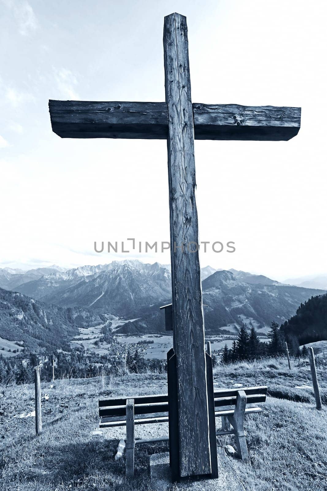 A summit cross in the Alps. A summit cross in the Allgaeu Alps. A summit cross in the evening light against the sky.