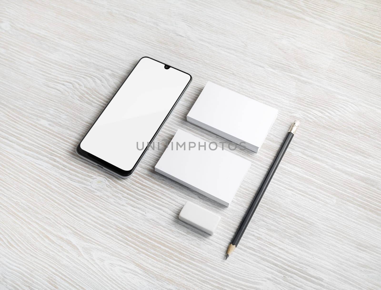 Blank stationery template for placing your design. Smartphone, business cards, pencil and eraser. Mockup for branding identity.