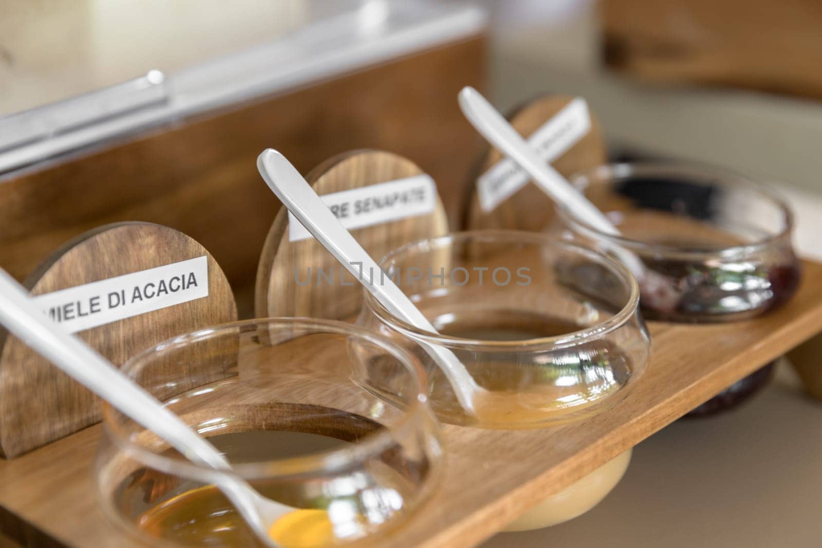 Small jars of honey. Natural light. Shallow DOF.