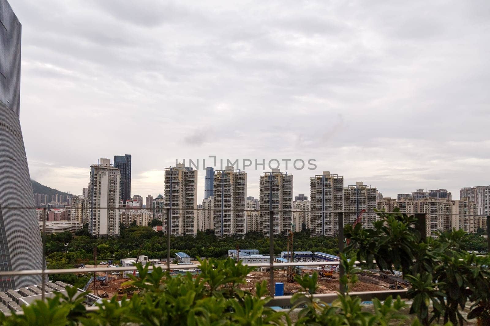 View of the construction of municipal residential buildings in a metropolis from a rooftop cafe, Shenzhen, China, Asia