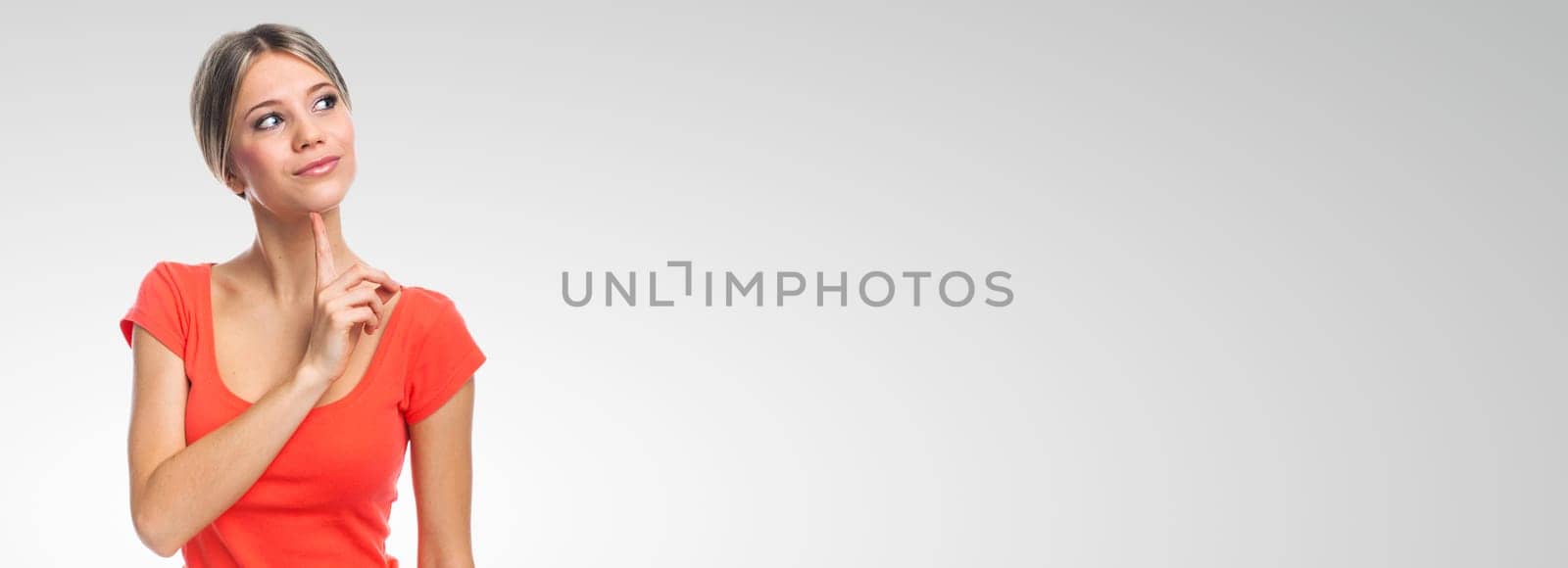 Young woman thinking and looking, on white