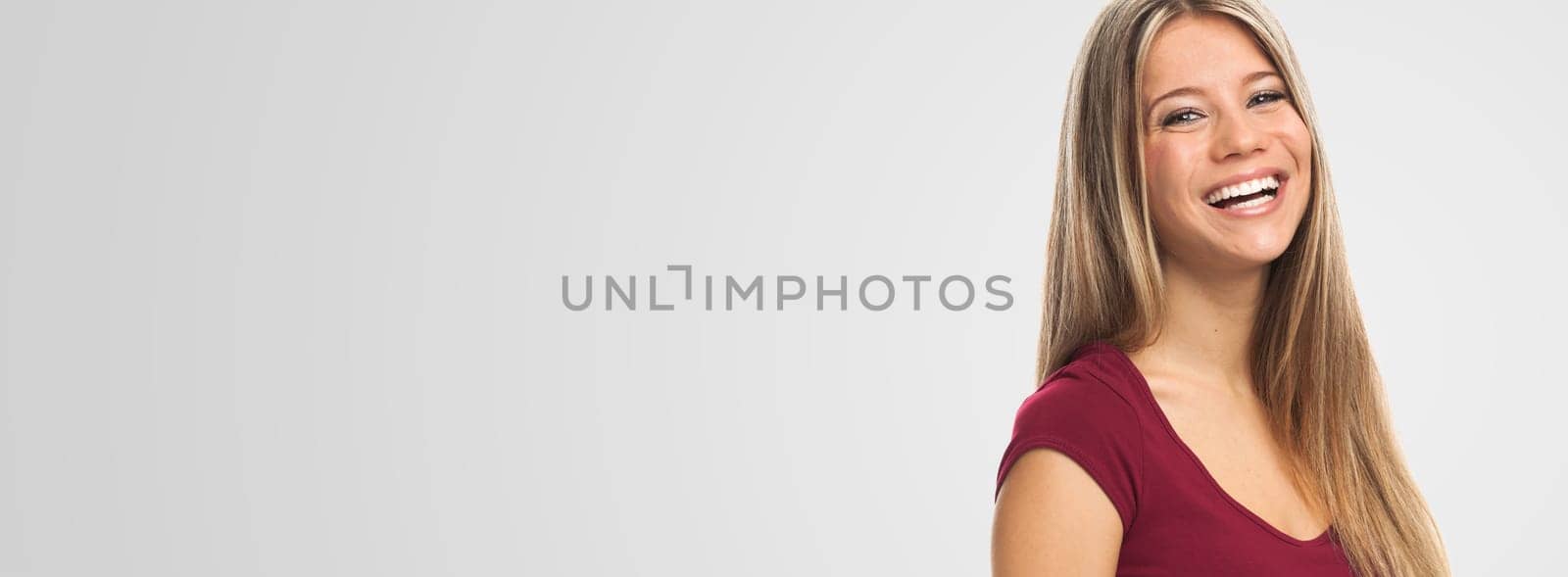 Portrait of a pretty blond young woman , on white