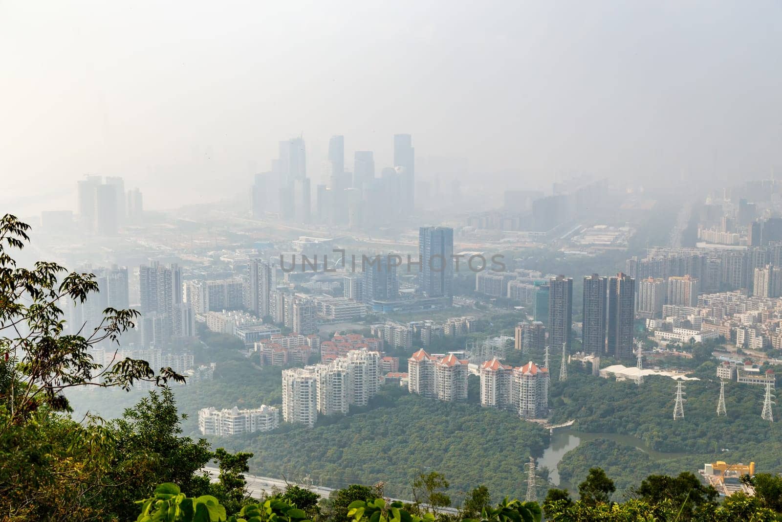 View of the foggy city from the mountains in the early morning, Shenzhen, China, Asia
