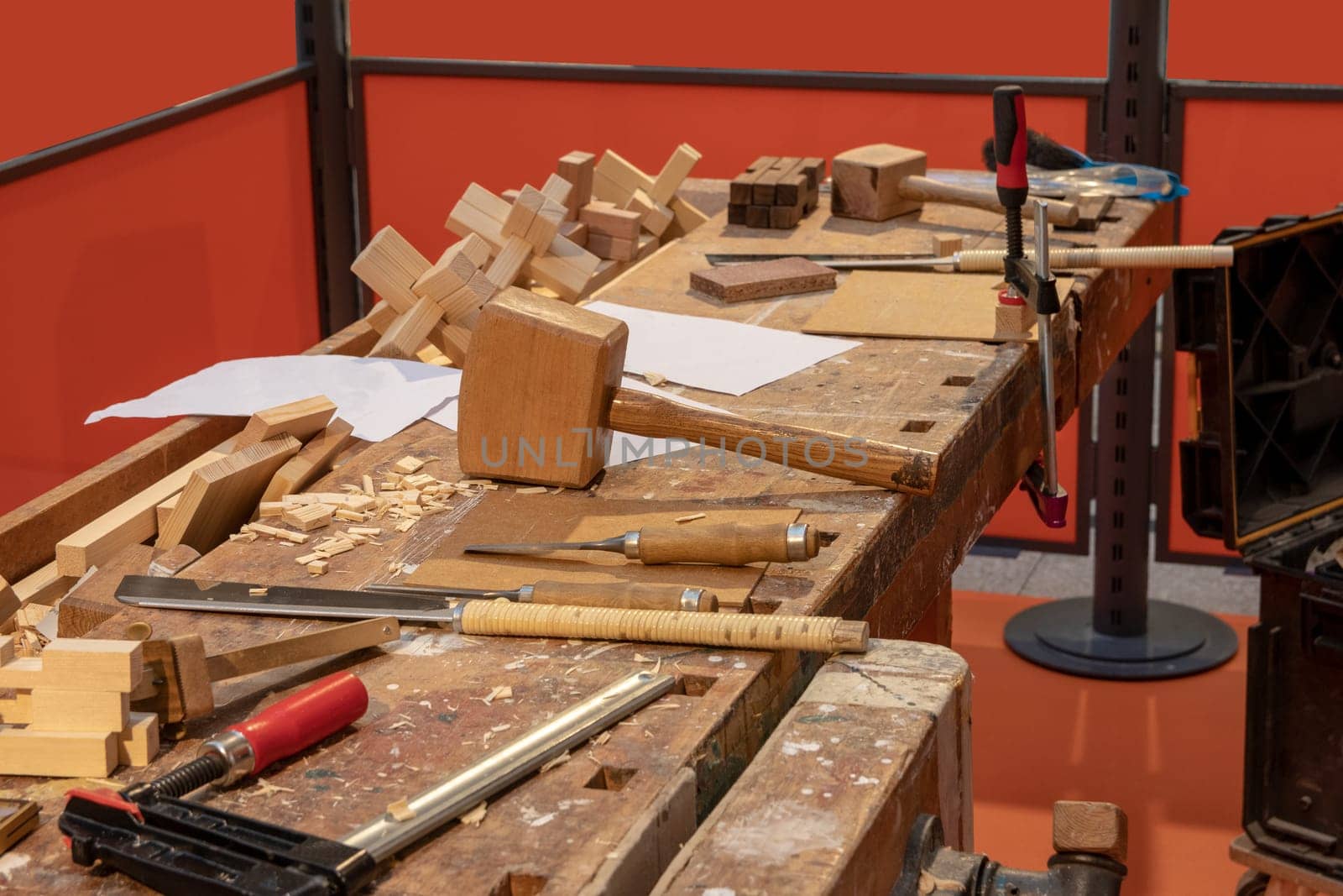 Carpentry workshop. A workbench in a carpentry with professional tools which the carpenter uses. Saws, screw clamps, mallet and wooden plane.
