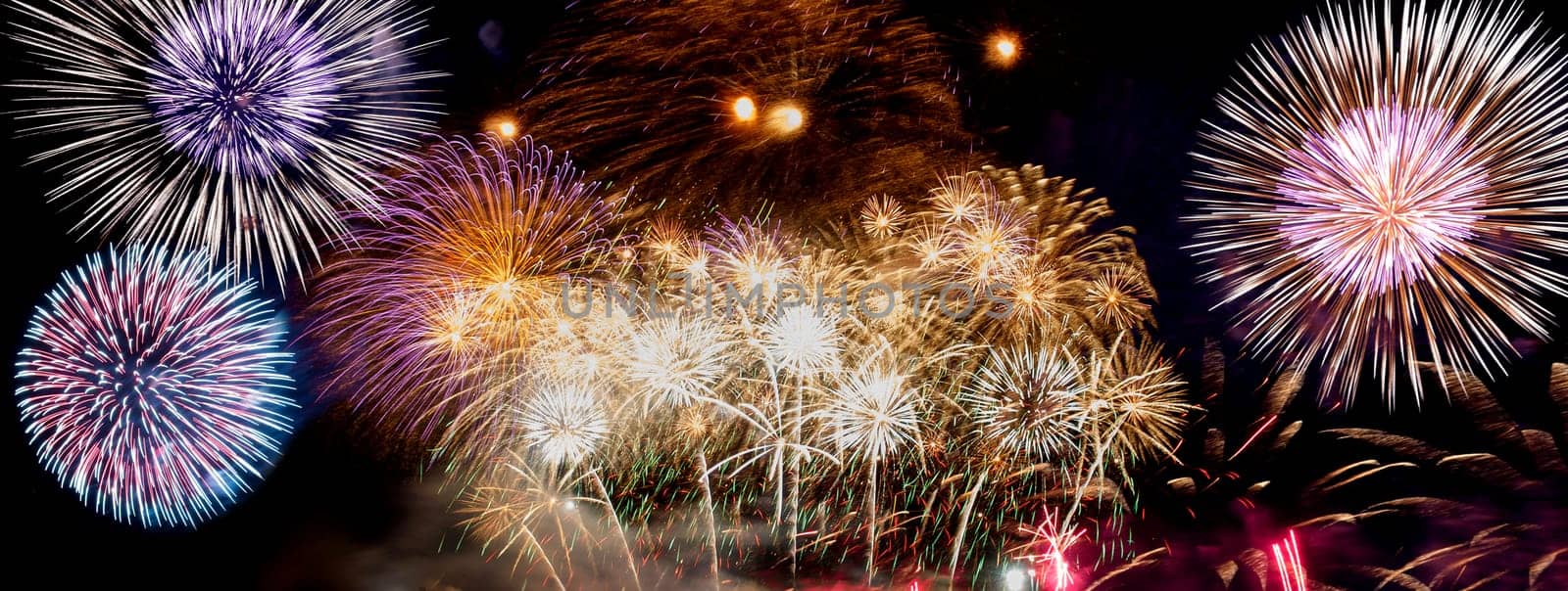A compilation of fireworks on a long horizontal image.