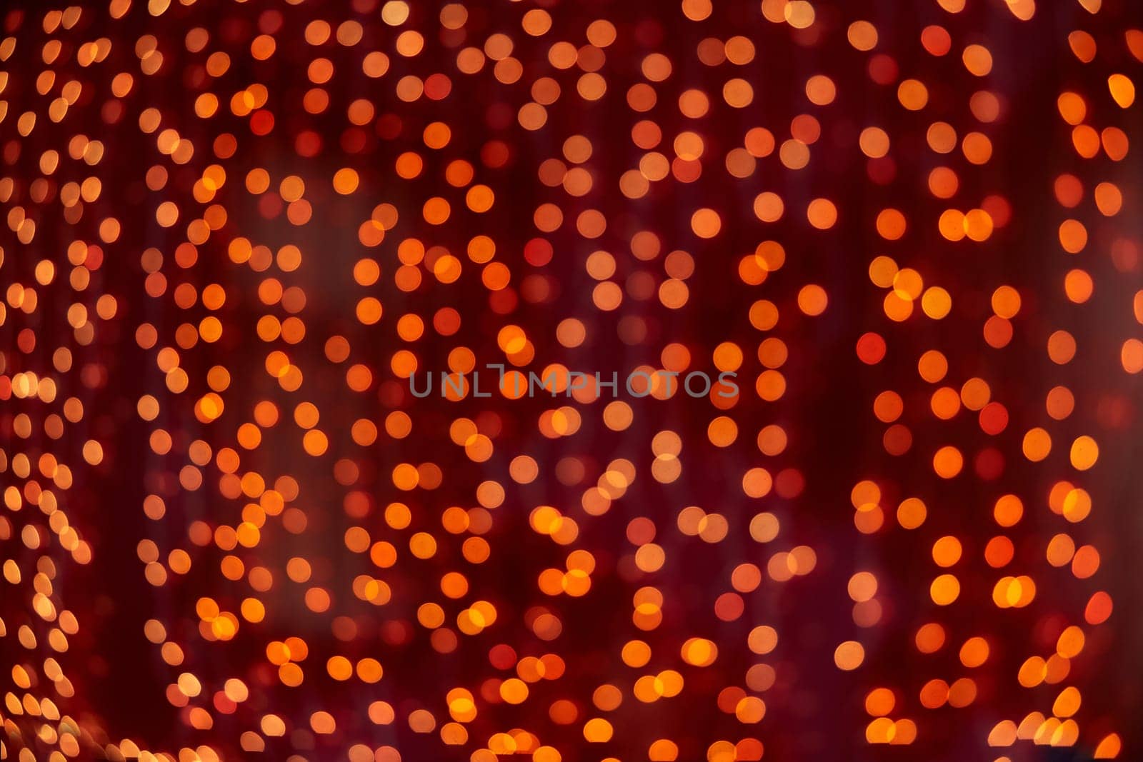 Festive background with LED lights garland. Christmas and New Year background. Blurred bokeh from the lights of a garland.