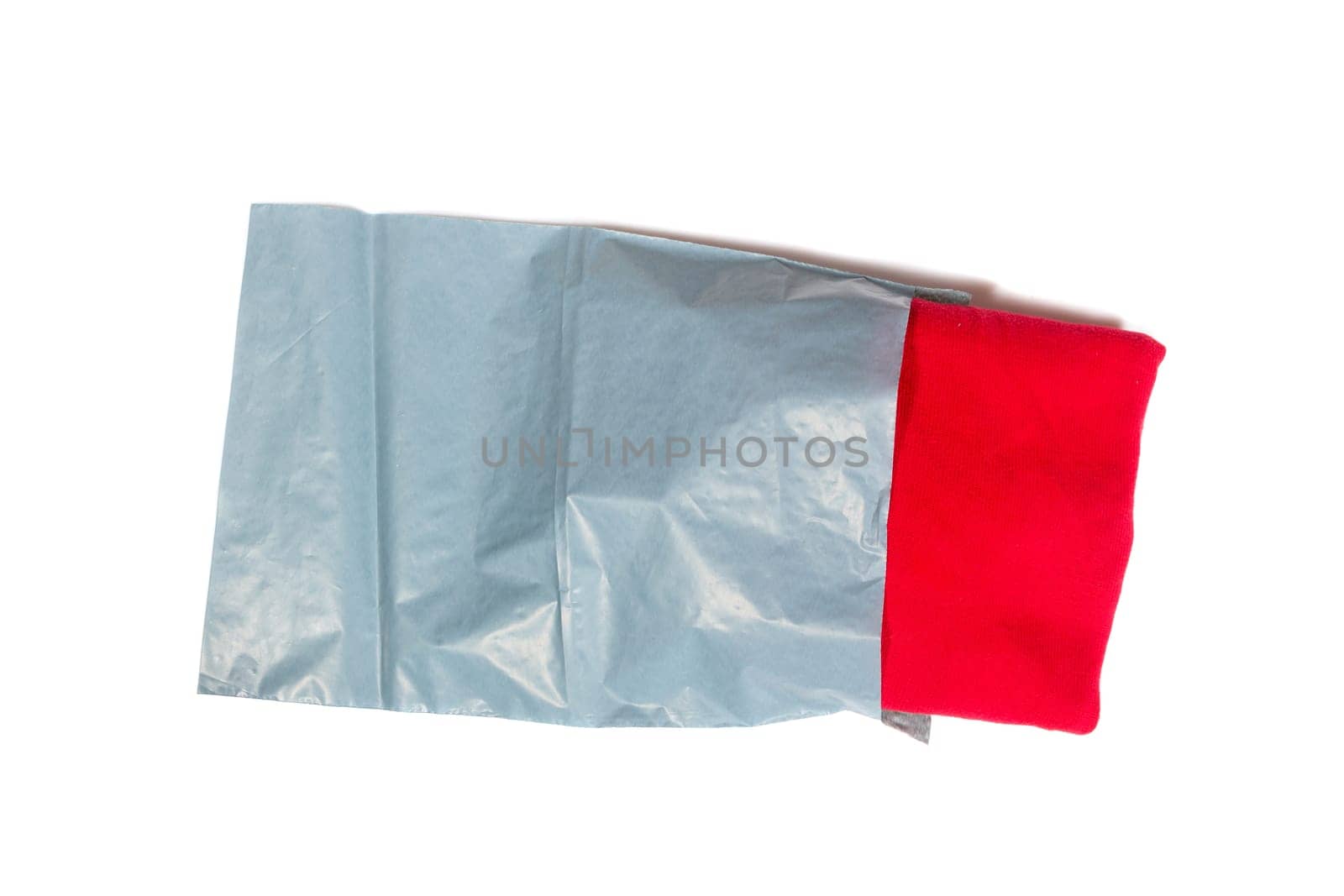 red jumper packed in gray mailing bag
