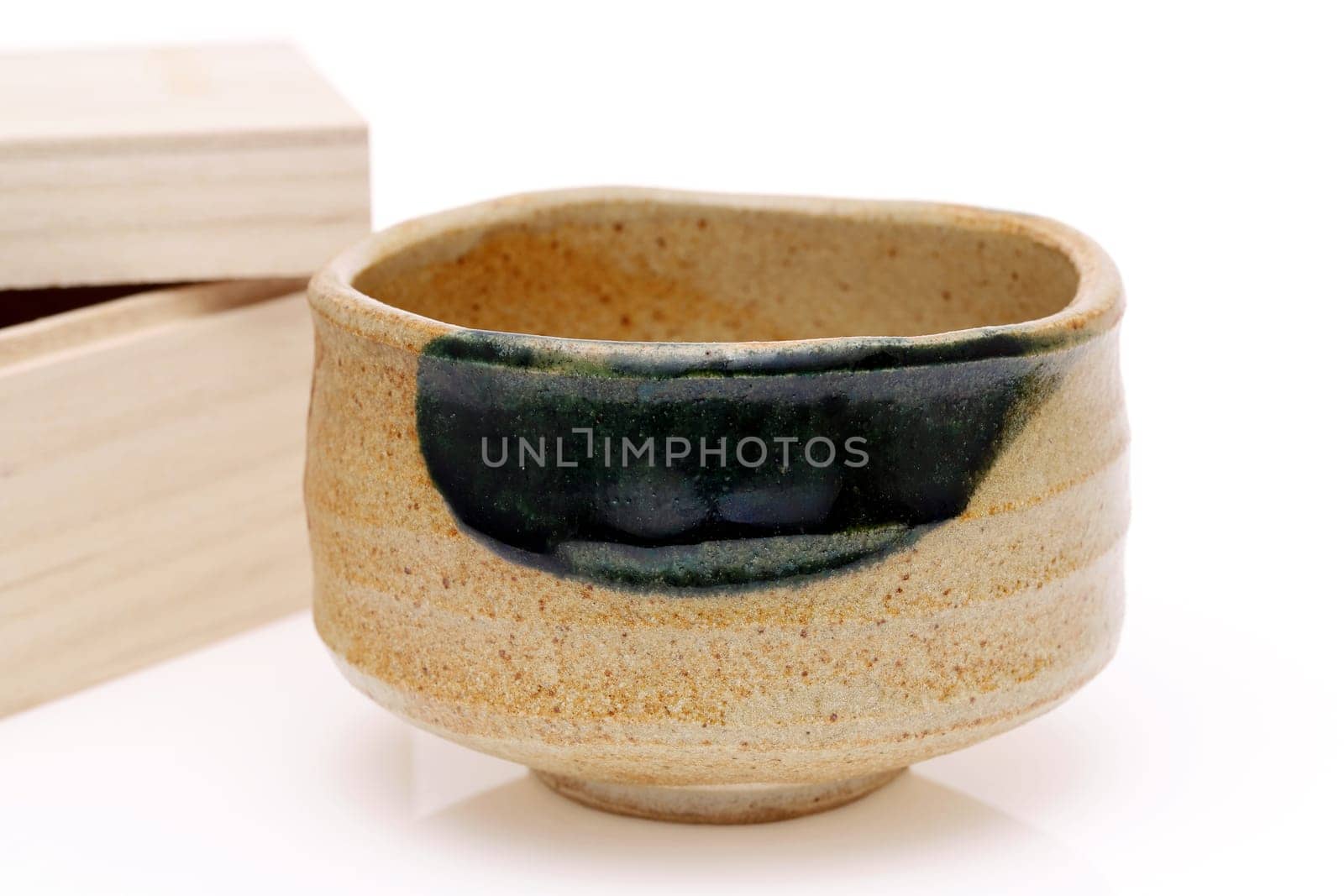 Single tea bowl used in Japanese matcha tea ceremony on white hackgrond
