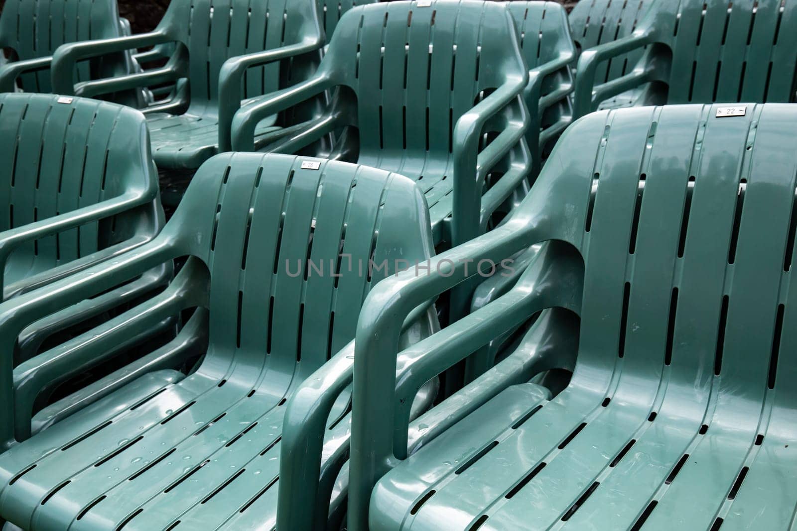 Stacked green plastic chairs in detail