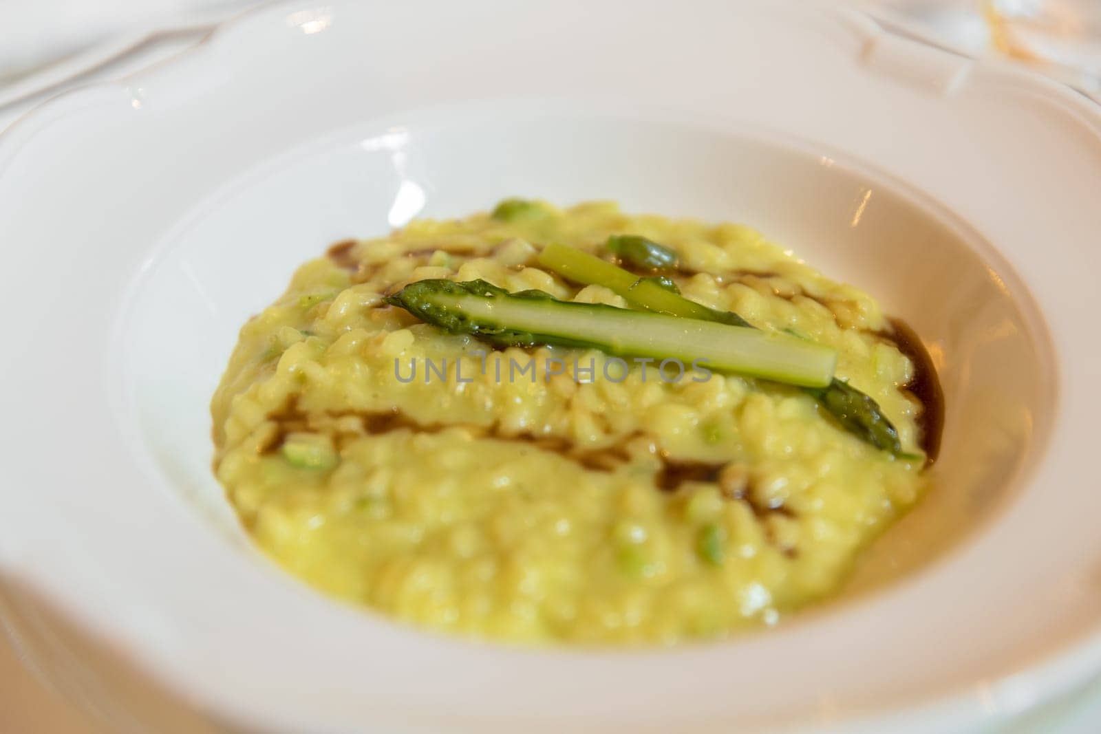 Italian saffron risotto with asparagus. Selective focus. Close- up.