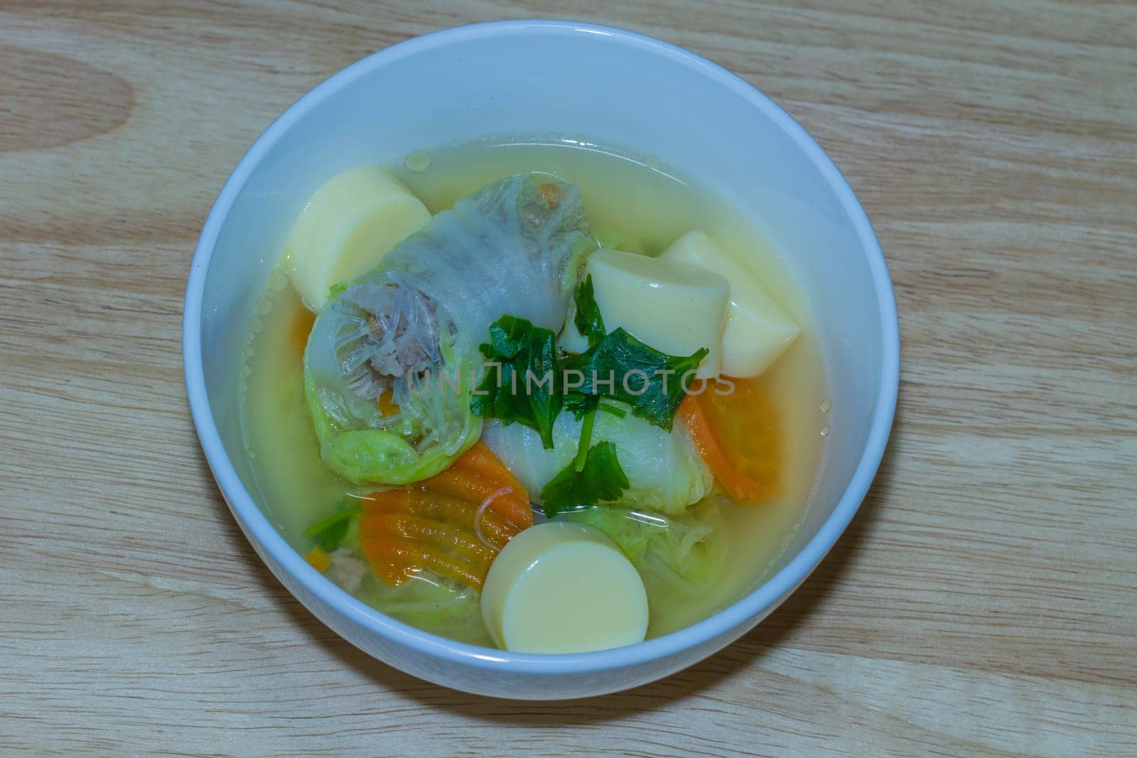 Clear soup with bean curd and minced pork on wooden
