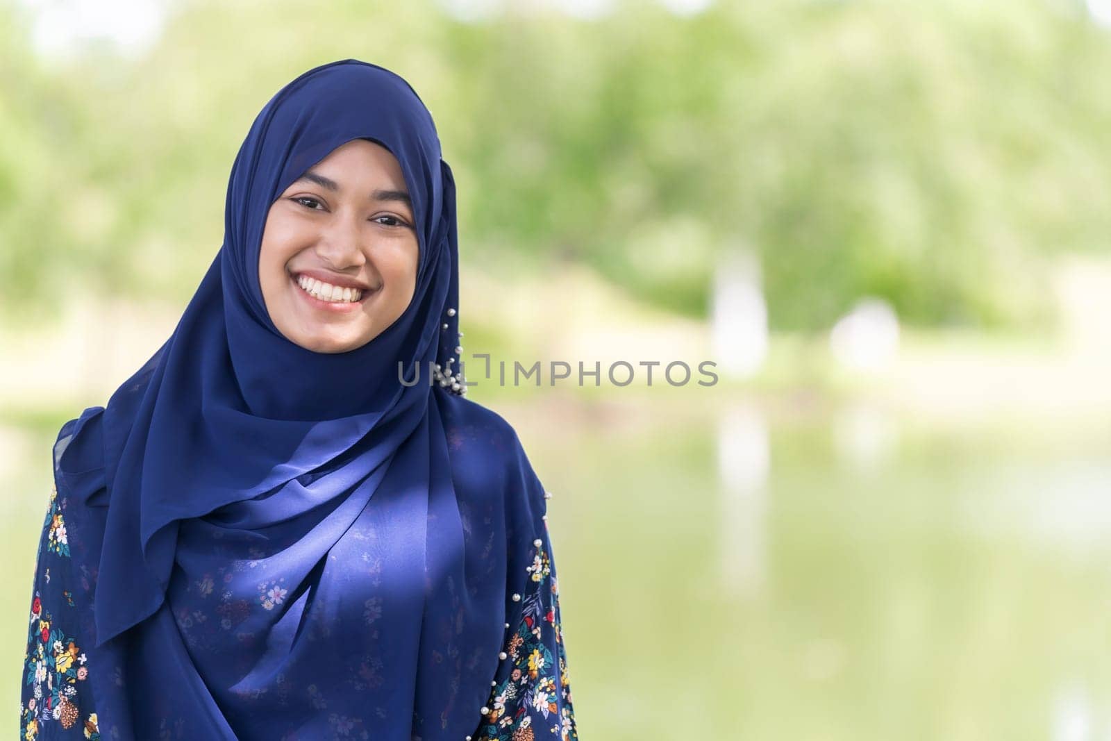 Portrait of good-looking Happy young teenager Muslim islamic asian university girl
