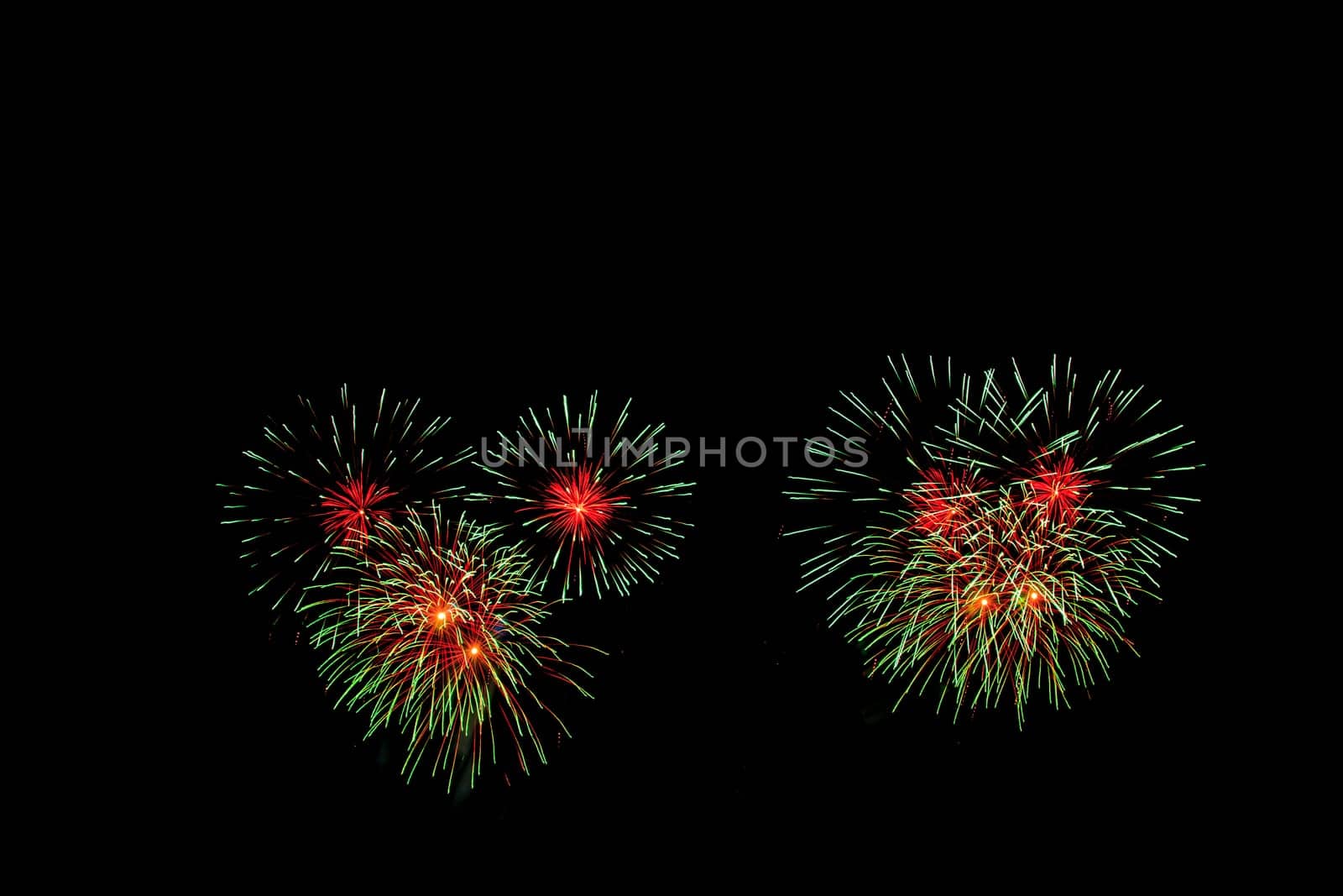 abstract Fireworks light up the dark sky background
