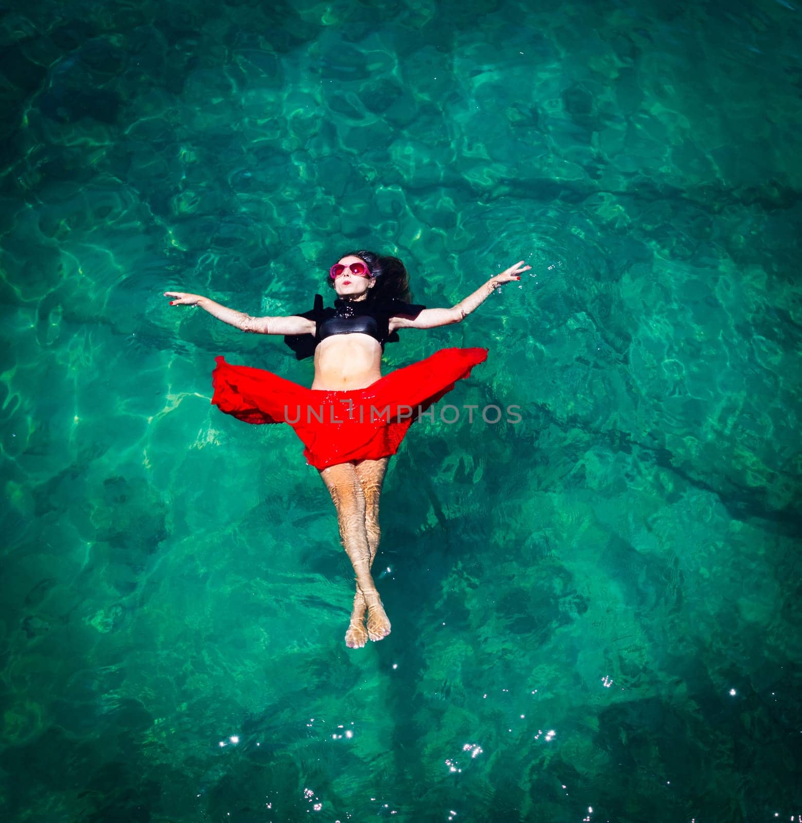 Aerial view of a beautiful woman dancing  in the sea