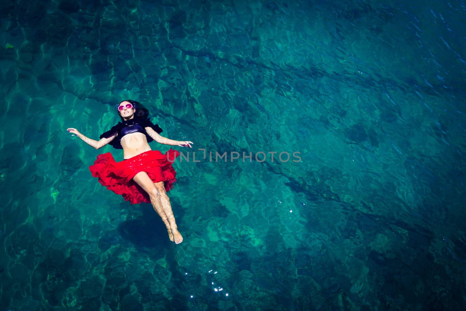 Aerial view of a beautiful woman dancing  in the sea