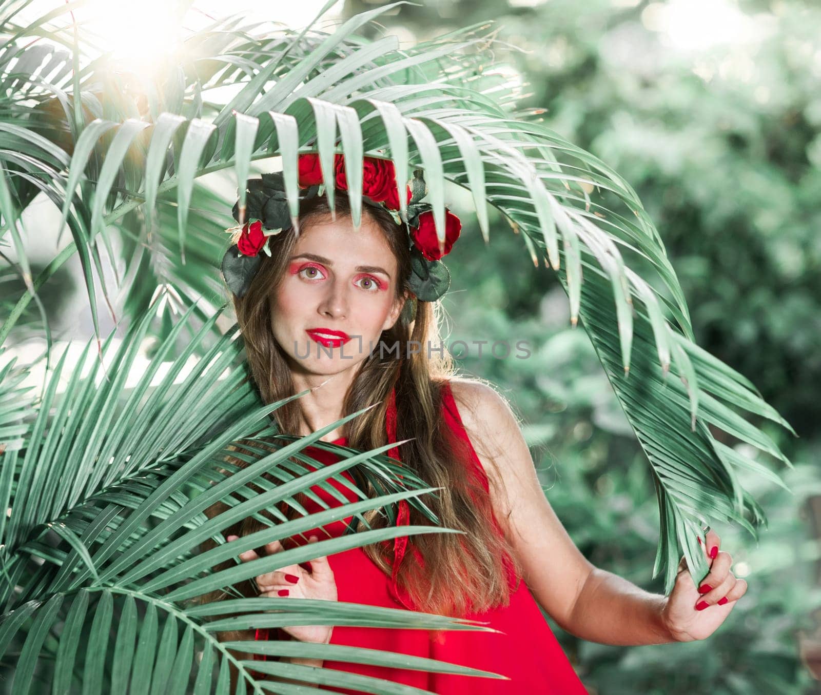 Fashion portrait of a beautiful woman in red dress outdoor
