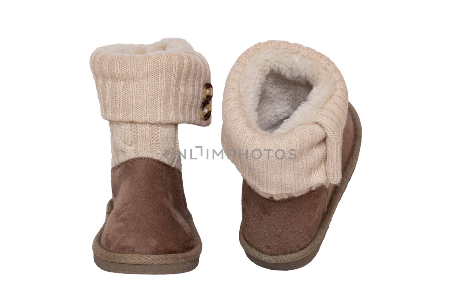 Winter boots. Close-up of a pair elegant brown suede leather winter boots with wool and lined with fur. Girls winter shoe fashion new collection. Isolated on a white background. Macro.