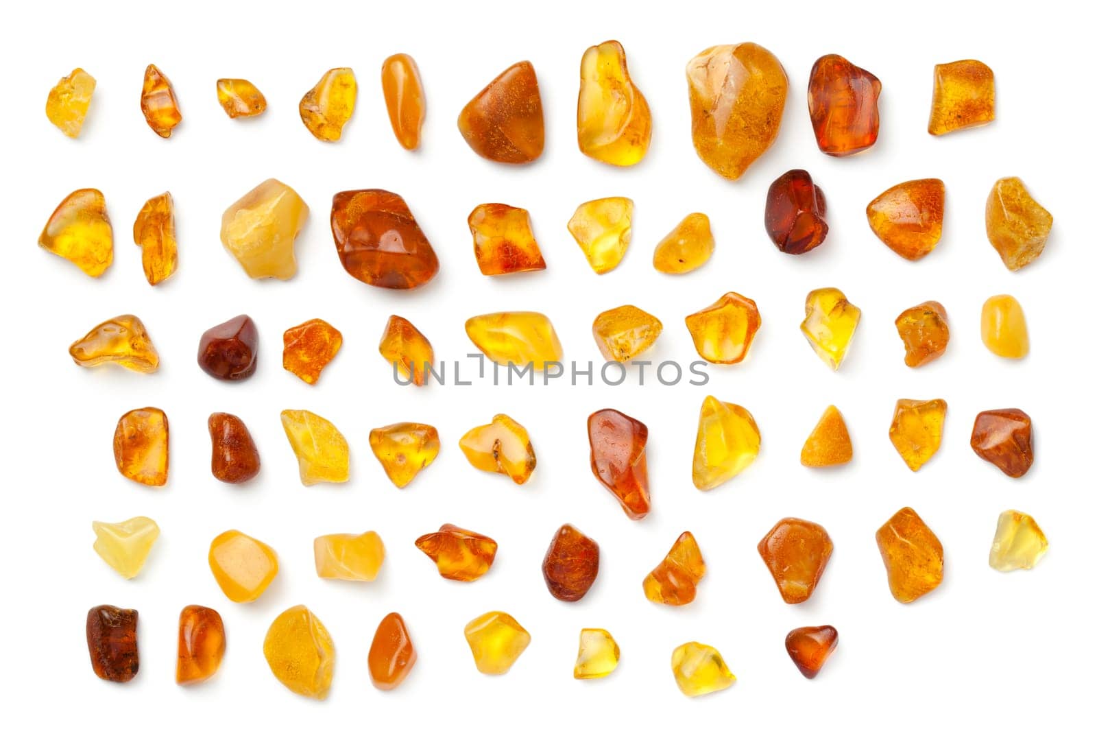 Amber isolated on white background. Collection of polished ambers. Top view, flat lay