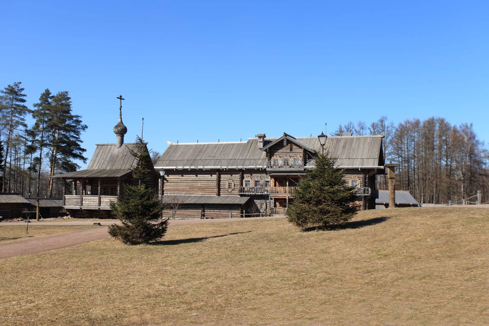 ordinary old wooden rural house  with a chapel and patch
