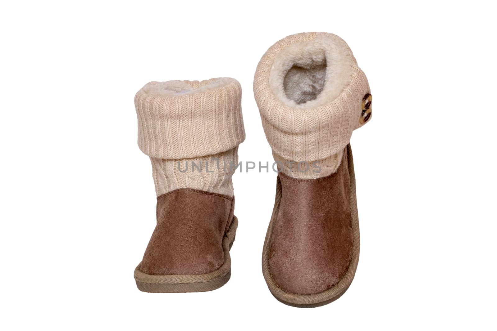 Winter boots. Close-up of a pair elegant brown suede leather winter boots with wool and lined with fur. Girls winter shoe fashion new collection. Isolated on a white background. Macro.