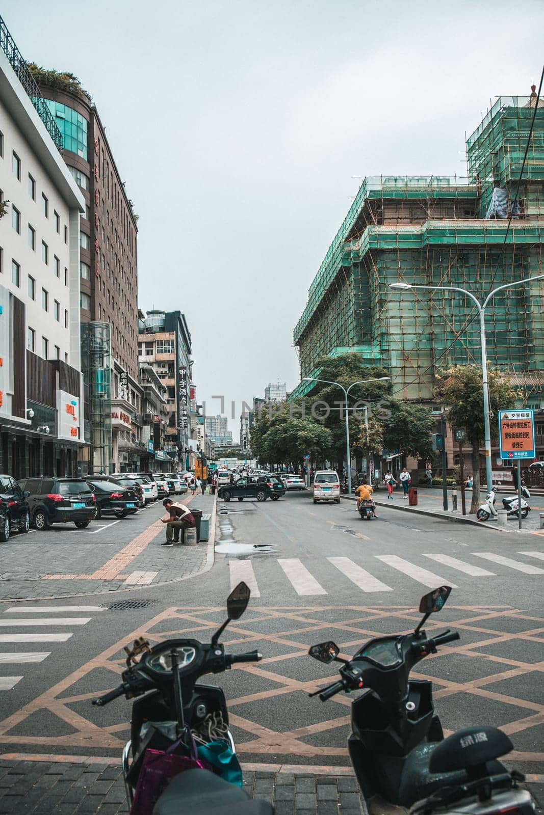 Xian, China -  July 2019 : Scooters parked on a street in the city of Xian in summer, Shaanxi Province