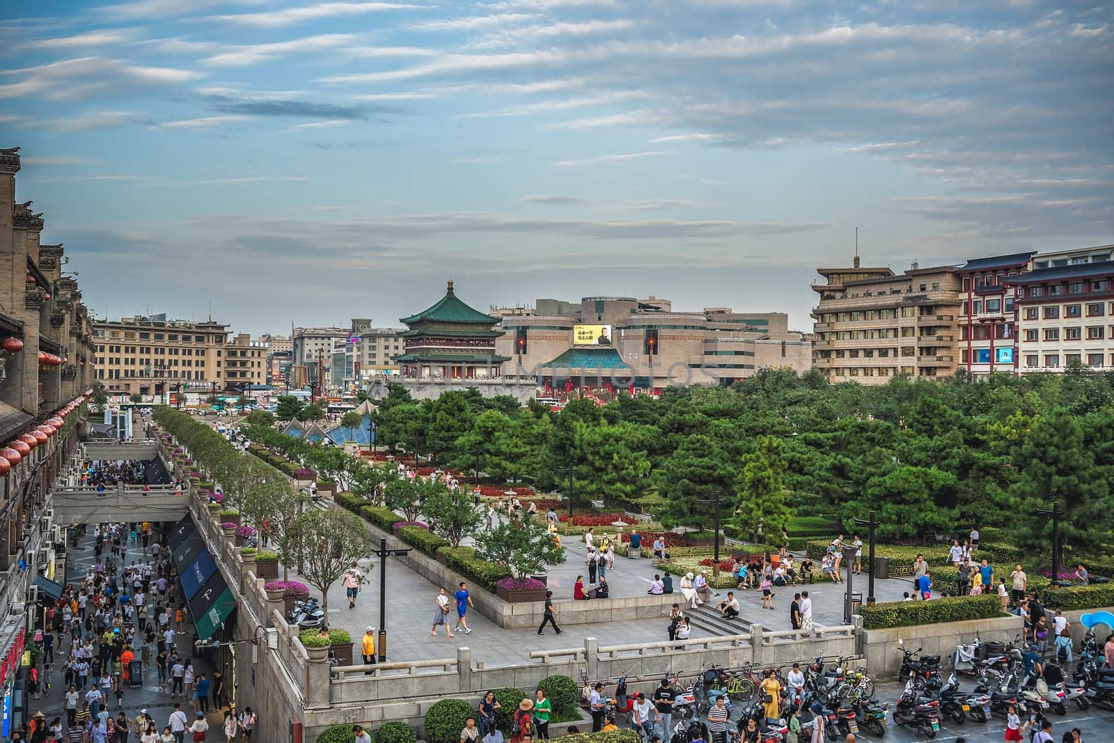 Xian, China -  July 2019 : Crowds walking on streets and town square with landmark Drum Tower in the background, Shaaxi Province