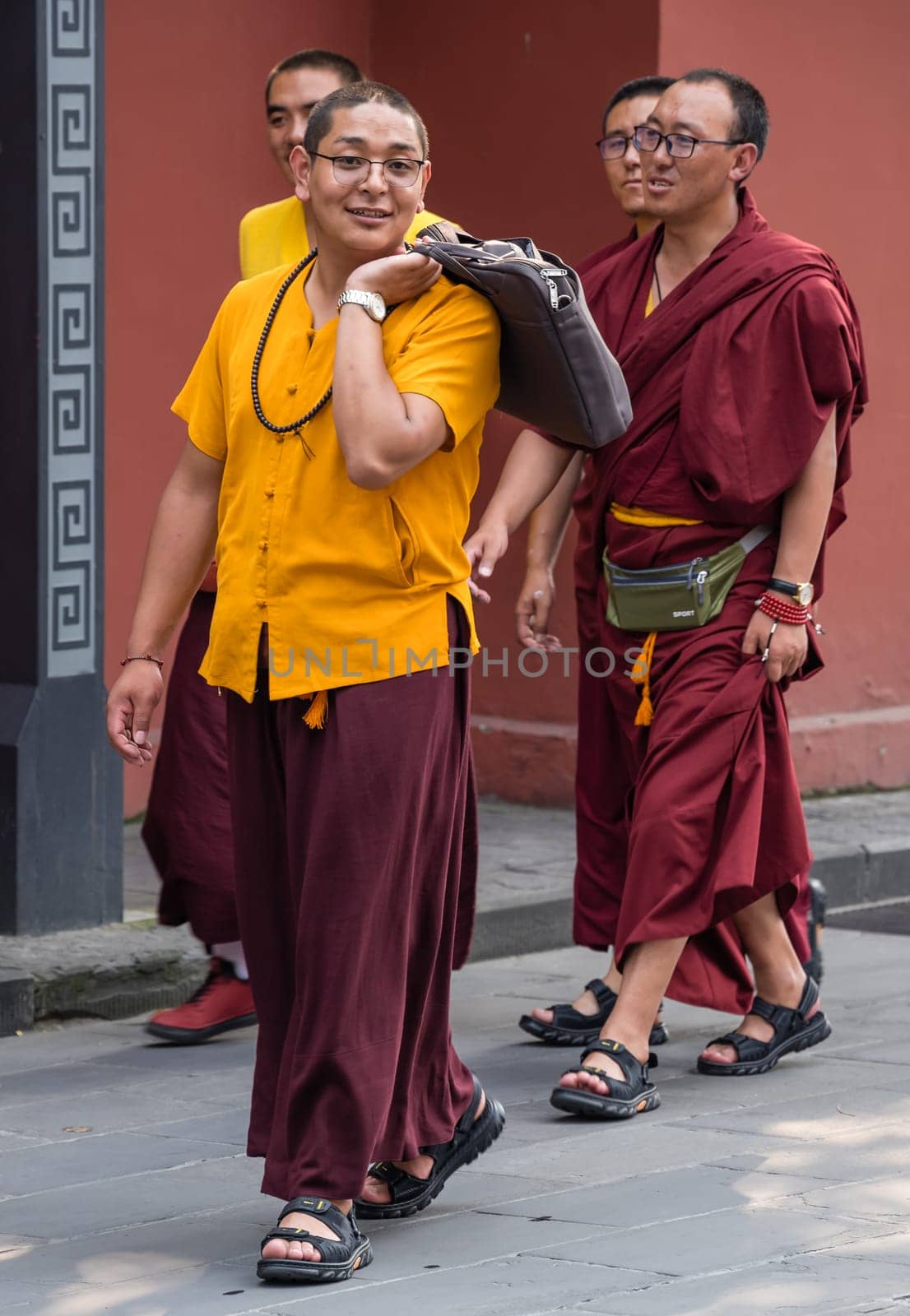 Chengdu, China -  July 2019 : Group of Buddhist Monks walking on a street in Chengdu town, Sichuan Province