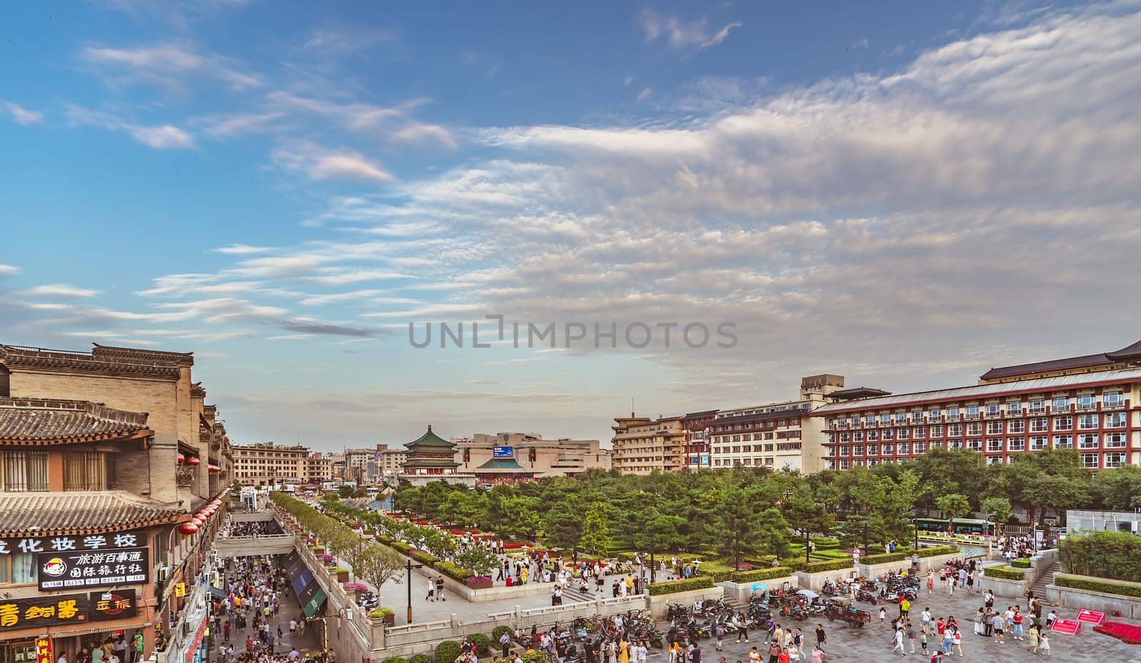 Xian, China -  July 2019 : Crowds walking on streets and town square with landmark Drum Tower in the background, Shaaxi Province