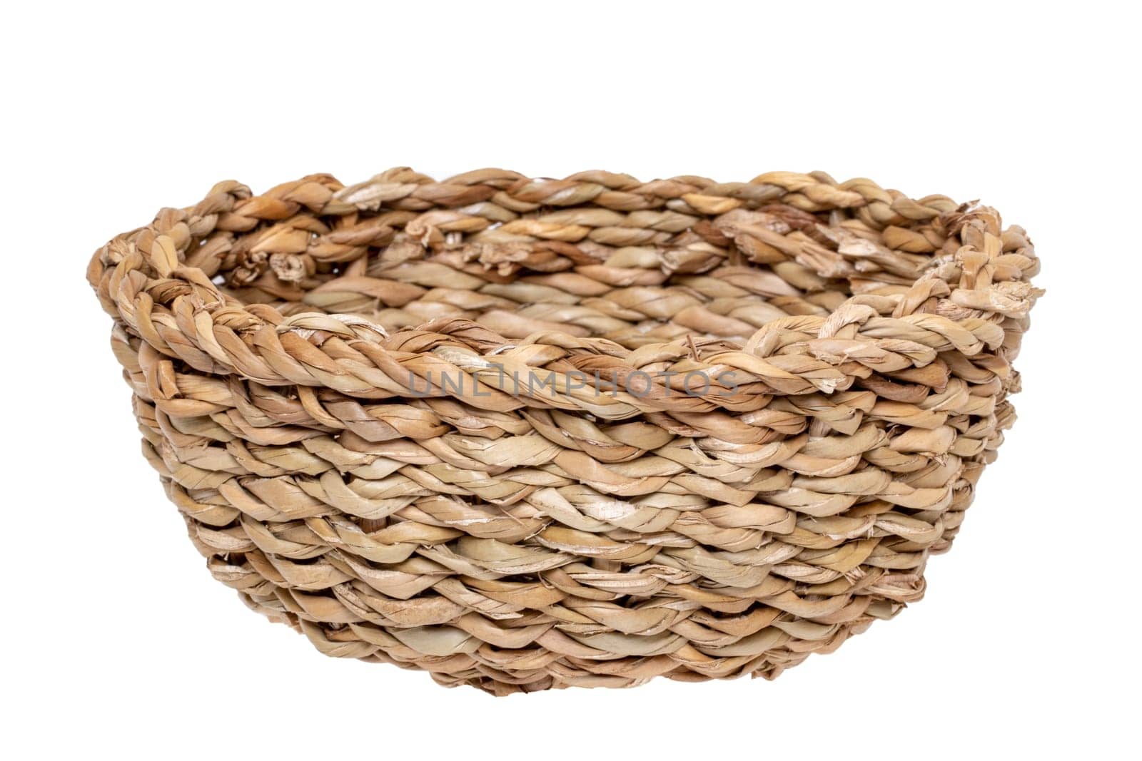 Empty basket. Close-up of a empty straw basket isolated on a white background. For your food and product display montage. Macro.