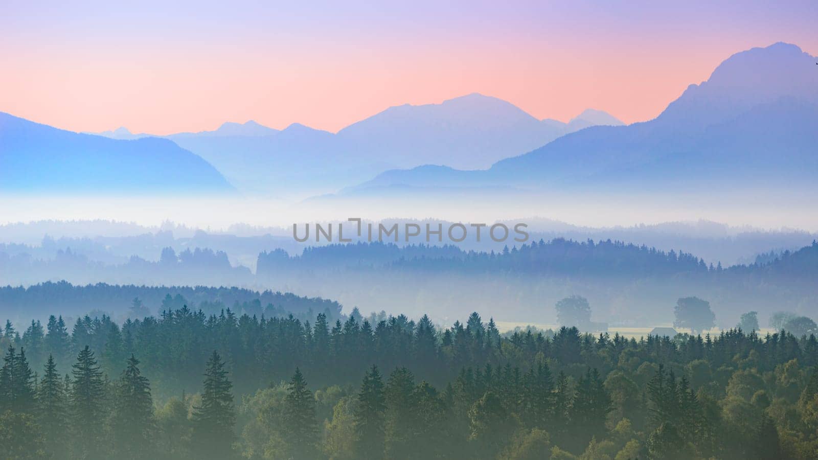 Aerial panoramic landscape of Upper Bavarian foggy foothills with morning sunrise over Alps mountains