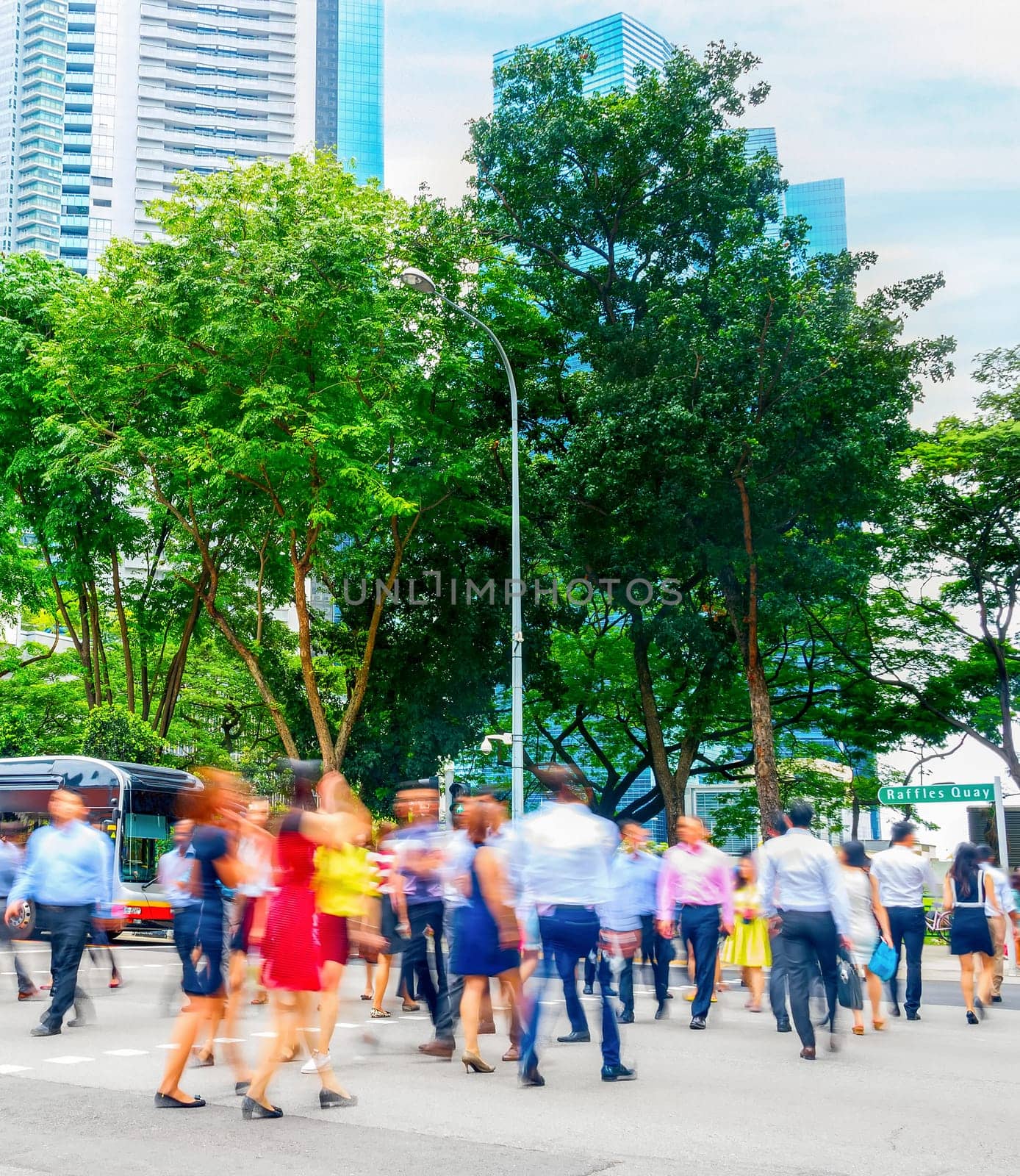 Cityscape with crowd of business people crossing road in Singapore downtown, metropolis skyline in background