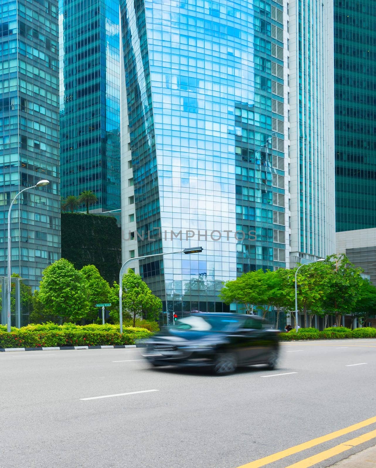 Rush hour in Singapore Downtown Core, car traffic on the road, modern architecture motion blur