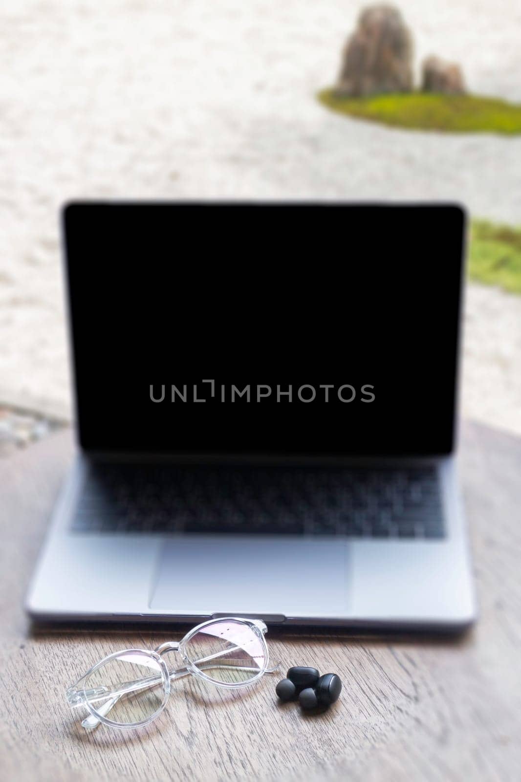 Modern laptop computer on wooden table in home garden, stock photo