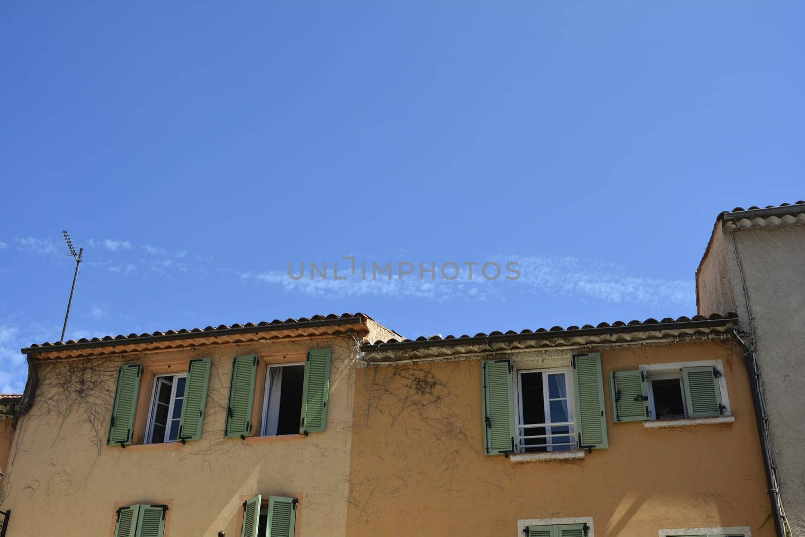 Orange House facade in the old town of Saint Tropez, France, with many blue sky and copy space