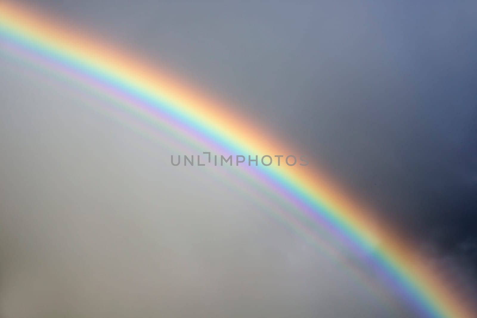 rainbow against a stormy grey sky