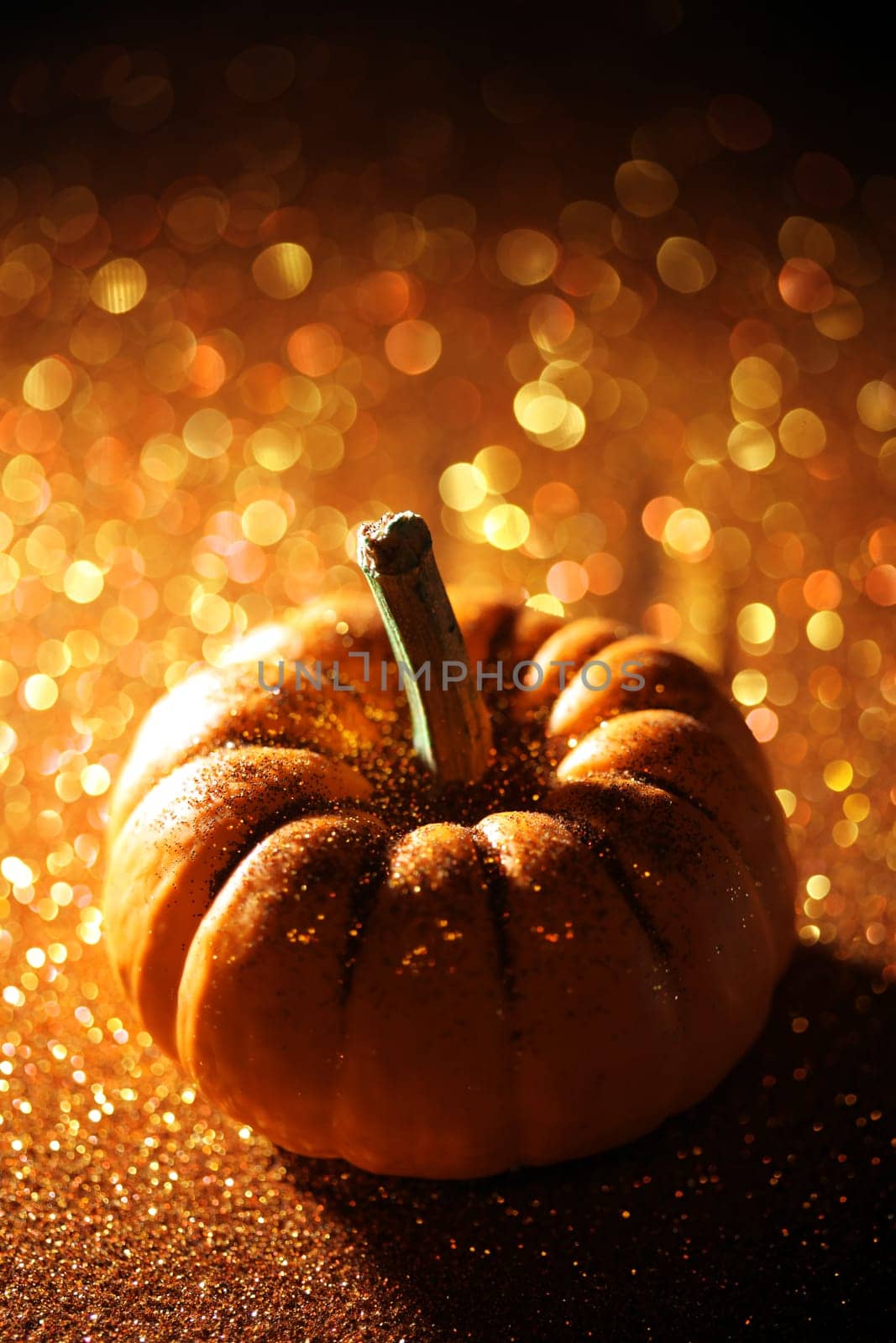Single pumpkin on sparkly orange background