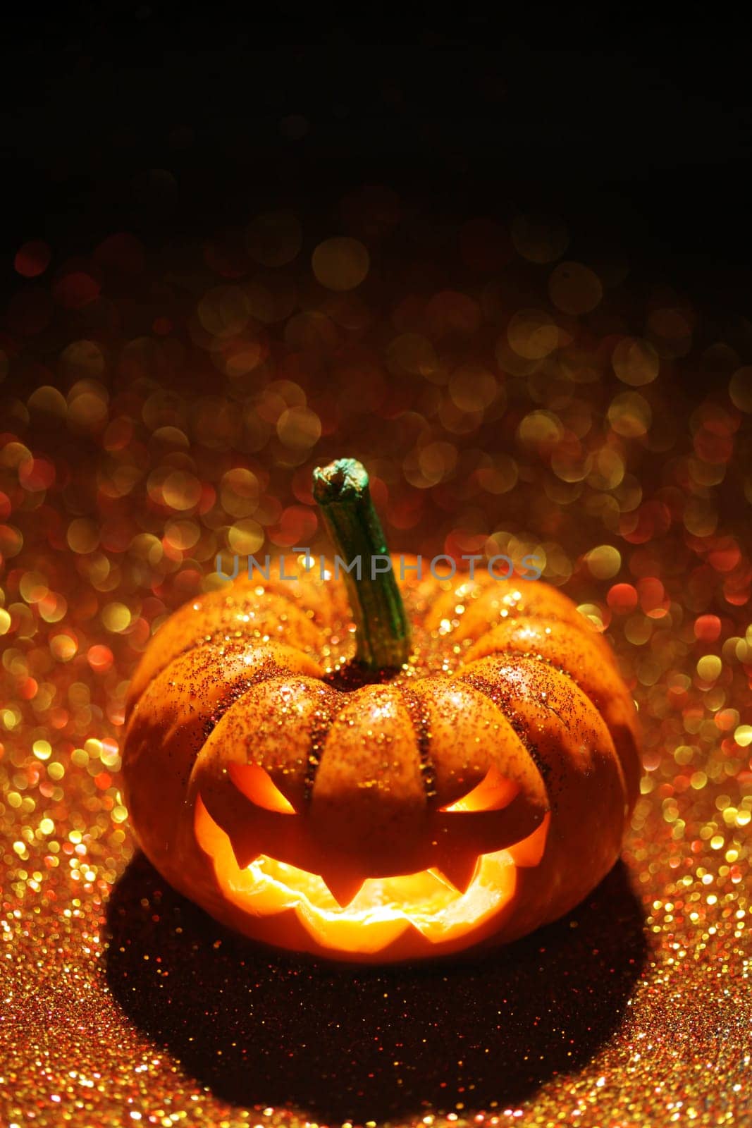 Glowing Jack-o-Lantern on sparkly orange background
