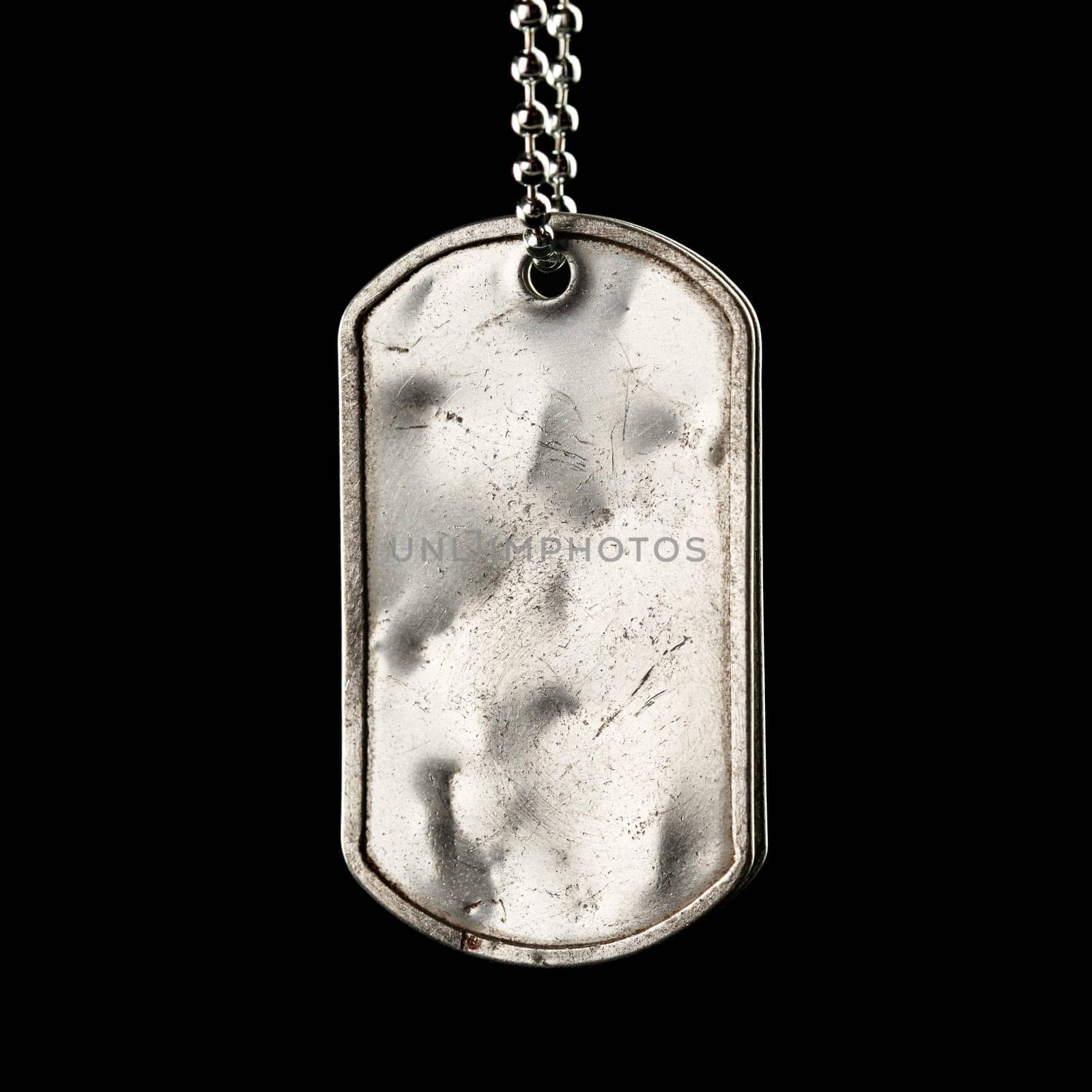 Old and worn blank military dog tags isolated on black